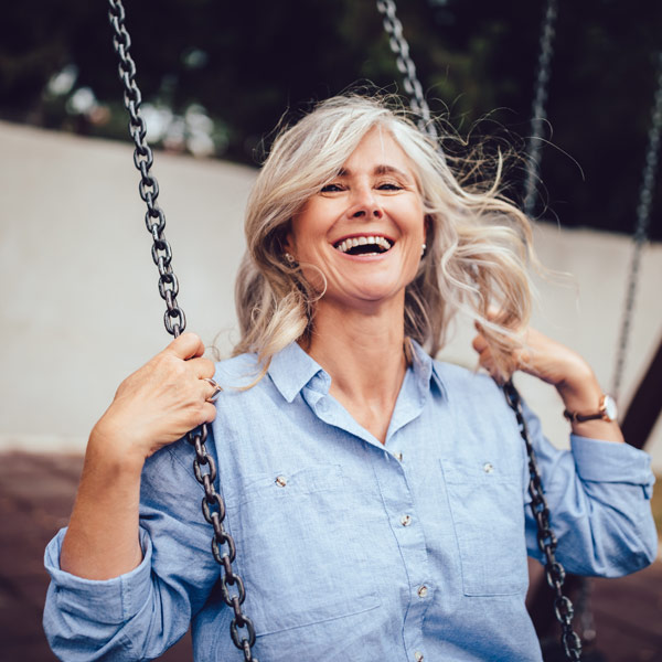 senior woman swinging and having fun